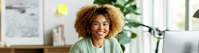 women in office smiling at Camera