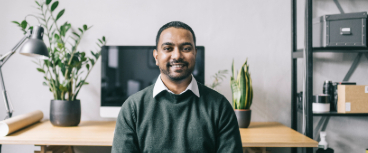 Man in office smiling at camera