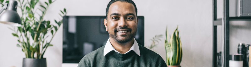 Man in office smiling at camera