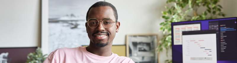 man in office smiling at camera