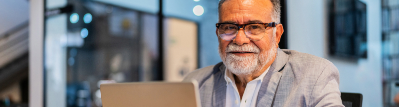 Man in office smiling at camera