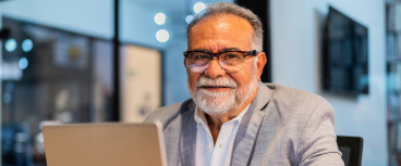 Man in office smiling at camera