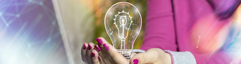 Concept showing lightbulb being held in palm of hands